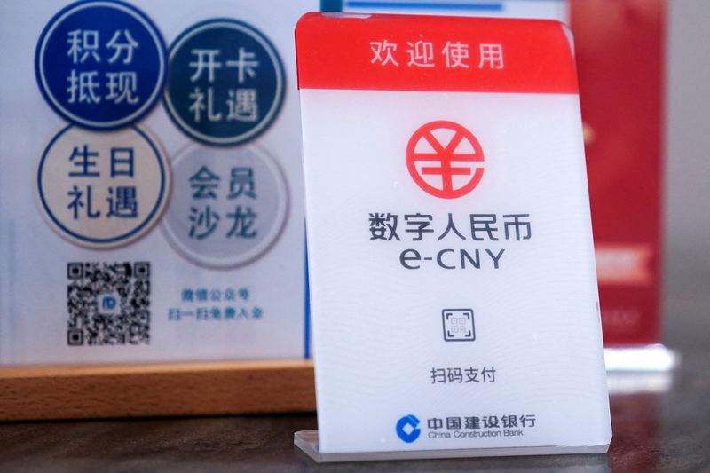 FILE PHOTO: A sign indicating digital yuan, also referred to as e-CNY, is pictured at a shopping mall in Shanghai, China