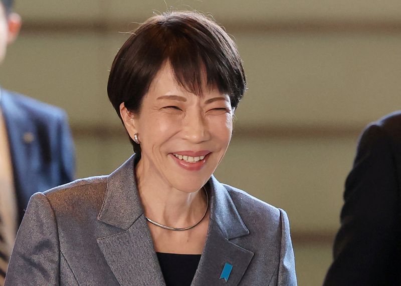 FILE PHOTO: Japan's Prime Minister Sanae Takaichi smiles at the Prime Minister's Office in Tokyo