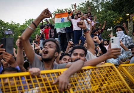 Supporters of India's Cockroach Janta Party (CJP) celebrate after India's Education Minister Dharmendra Pradhan resigned, in New Delhi